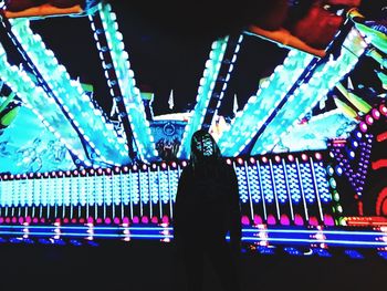 Rear view of silhouette man standing at night