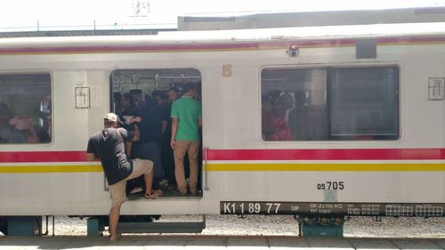 People on train at railroad station platform