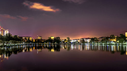 Illuminated city against sky at night