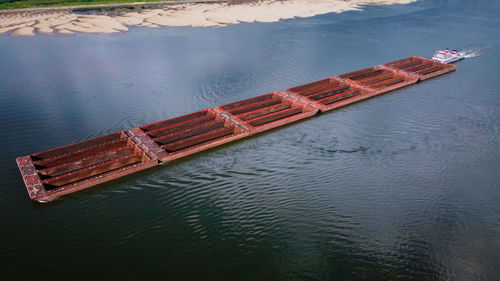 An empty coal barge on the mississippi river as seen from a drone's view in early september 2022