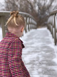 Girl walking on snowy footbridge