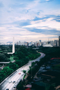 High angle view of street amidst buildings in city against sky