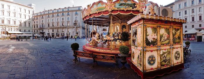People on street amidst buildings in city
