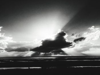 Silhouette of man against storm clouds