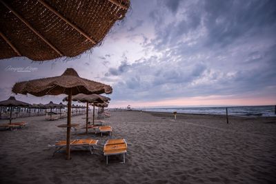 Scenic view of beach against sky during sunset