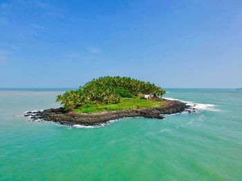 Scenic view of island in sea against sky