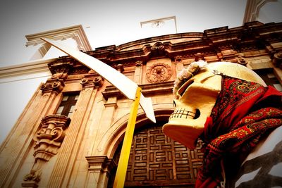 Low angle view of statue against temple