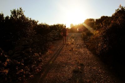 Rear view of person walking on road
