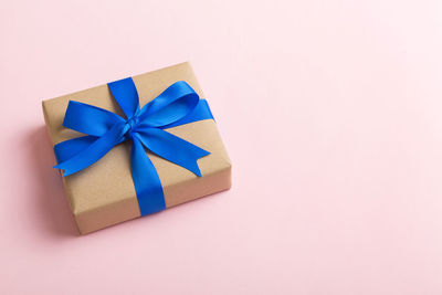 High angle view of gift box against pink background