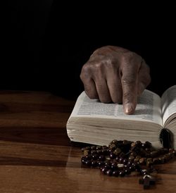 Cropped hand of person preparing food on table