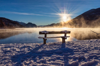 Scenic view of snowcapped mountains by lake against sky