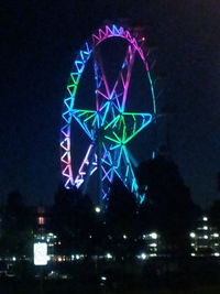 Low angle view of illuminated ferris wheel