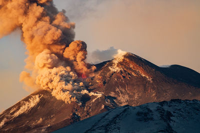 Close-up of volcanic mountain against sky during winter