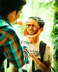 Midsection of man holding hands outdoors