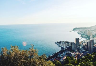 High angle view of sea and cityscape against sky