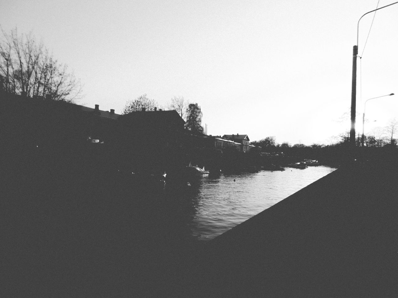 RIVER BY SILHOUETTE TREES AGAINST SKY