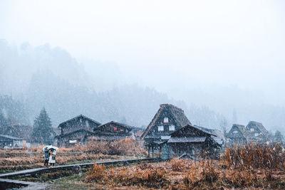 Built structure on land against sky during winter