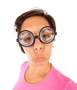 Close-up portrait of woman wearing eyeglasses against white background