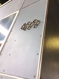 Low angle view of text on metal door