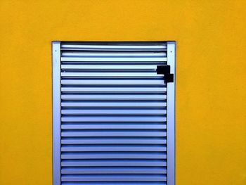 Close-up of yellow window on wall