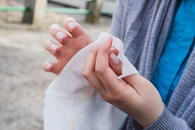 Midsection of woman holding tissue paper