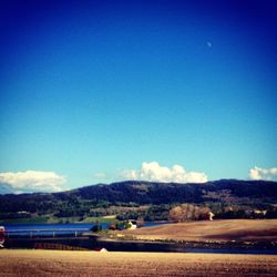 Scenic view of mountains against blue sky