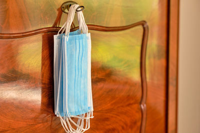 Close-up of blue bottle hanging on wood