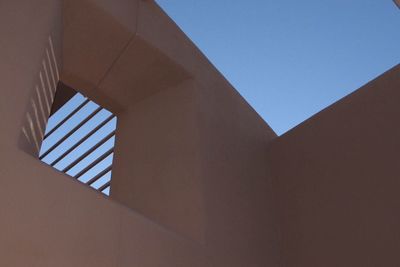 Low angle view of building against clear blue sky