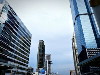 Low angle view of modern buildings in city against sky