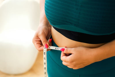 Midsection of woman wearing hat