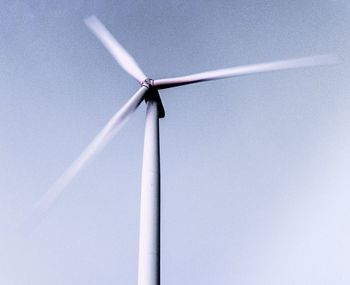 Low angle view of wind turbine against sky