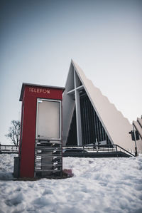 Built structure on snow against clear sky