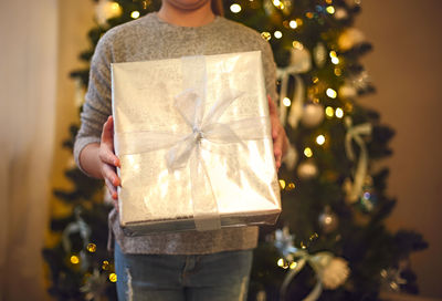 Man holding christmas tree in box
