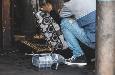 Low section of man working at workshop