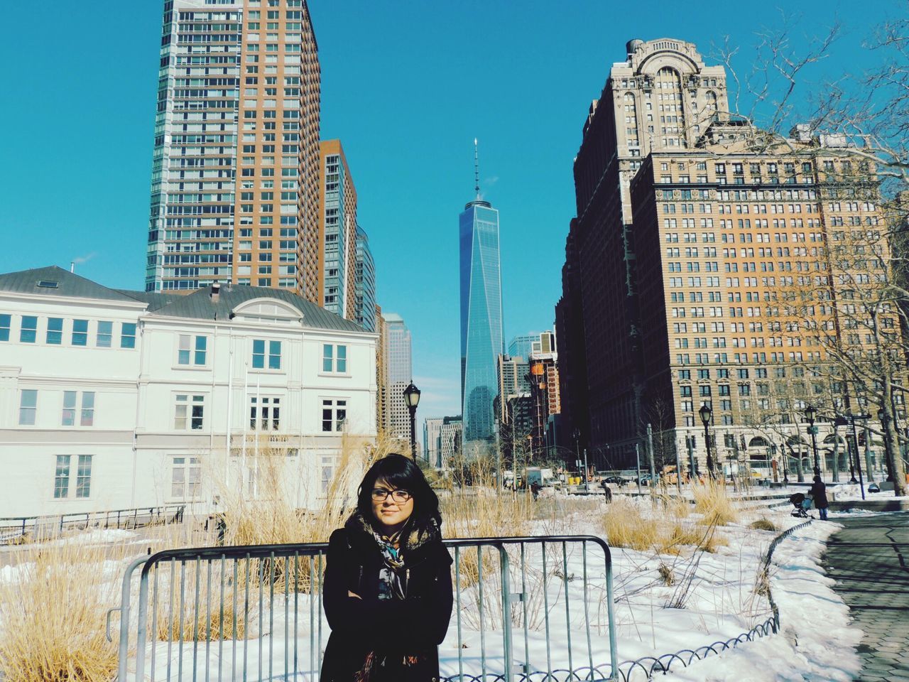 building exterior, architecture, built structure, lifestyles, city, leisure activity, standing, casual clothing, tower, young adult, blue, clear sky, headshot, person, waist up, tall - high, famous place, front view