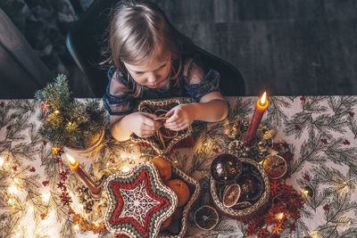 Girl and christmas decorating on the table 