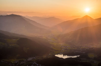 View of calm countryside lake at sunset