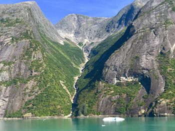 Scenic view of sea and mountains against sky