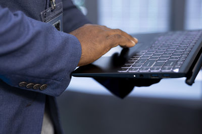 Midsection of man using laptop