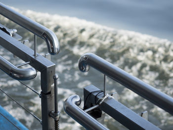 Close-up of metal railing against sky