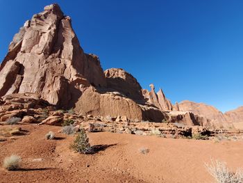 Scenic view of rocky mountains against clear blue sky