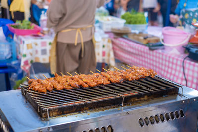 Meat cooking on barbecue grill in market