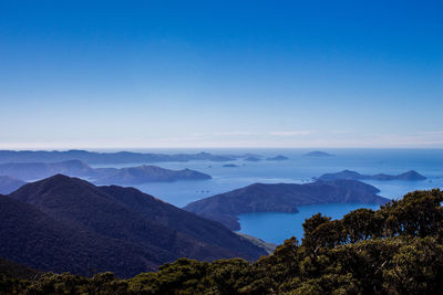 Scenic view of mountains against blue sky