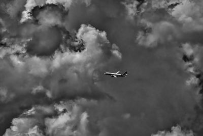 Low angle view of airplane flying in sky