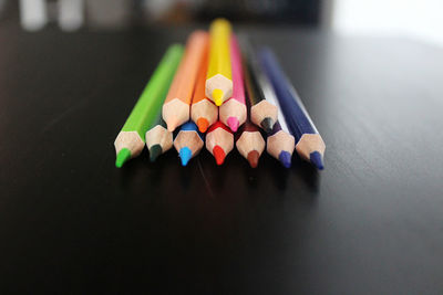 Close-up of multi colored pencils on table