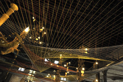 Low angle view of illuminated bridge at night