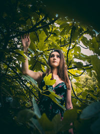 Portrait of smiling young woman with leaves