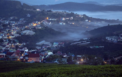 High angle view of illuminated buildings in city