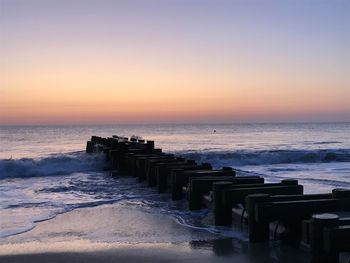 Scenic view of sea against clear sky during sunset