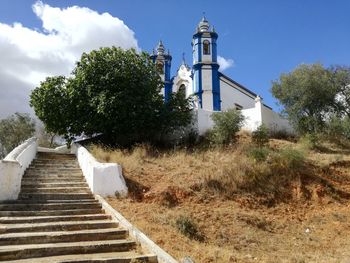 Low angle view of steps leading towards building against sky